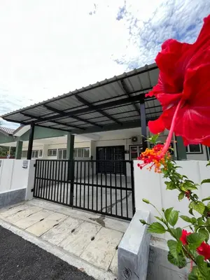 awning over a porch of a house with a red flower at Mama Zan Homestay in Seri Iskandar
