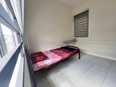 a small bed in a room with a window at Mama Zan Homestay in Seri Iskandar
