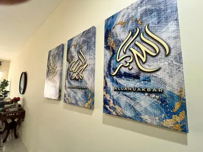 a group of three paintings on a wall at Mama Zan Homestay in Seri Iskandar