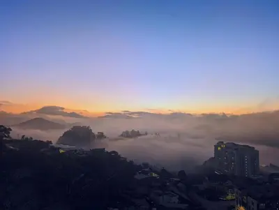 a view of a foggy city at sunset at Serene French Family Retreat with Sunrise View in Cameron Highlands