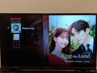 a television screen with a picture of a man and a woman at Serene French Family Retreat with Sunrise View in Cameron Highlands