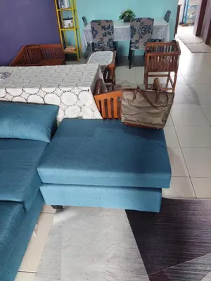 a group of blue couches sitting in a room at Jerai Geopark Cottage Alamanda in Baling