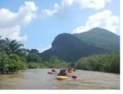 a group of people kayaking down a river at Jerai Geopark Cottage Alamanda in Baling