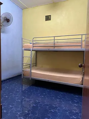 two bunk beds in a room with a fan at HOMESTAY Sg Petani in Sungai Petani