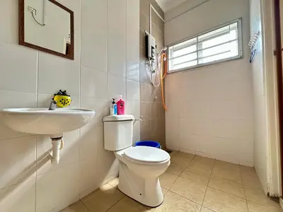 a bathroom with a toilet and a sink at Lovely Homestay in Gerik with Free Netflix & WiFi in Gerik