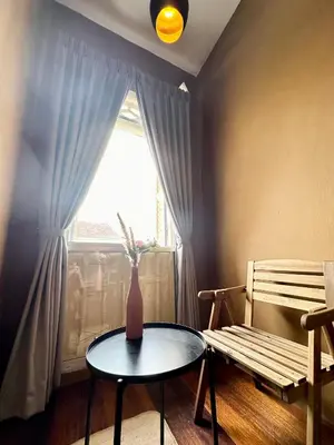 a room with a table and a bench and a window at Georgetown Cozy 7 Bedrooms 13 Pax in George Town