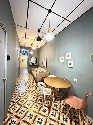 a living room with a table and a couch at Georgetown Cozy 7 Bedrooms 13 Pax in George Town