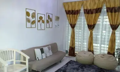 a living room with a couch and curtains at AL DHAKIYA HOMESTAY KULIM 3r2b in Kulim