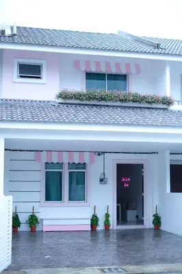 a white house with potted plants in front of it at Comfy Cafe 43 Homestay- Holiday Home in Tanah Rata