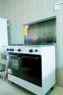 a kitchen with a stove top oven in a kitchen at Comfy Cafe 43 Homestay- Holiday Home in Tanah Rata