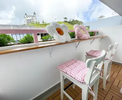 a balcony with two chairs and two stuffed animals at Comfy Cafe 43 Homestay- Holiday Home in Tanah Rata