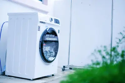 a washing machine sitting next to a building at Comfy Cafe 43 Homestay- Holiday Home in Tanah Rata