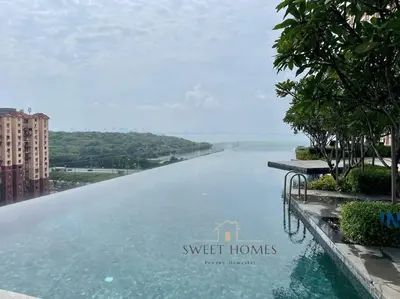 a infinity pool with a view of the water at Urban Modern3BR CityView 7pax Infinity Pool in George Town