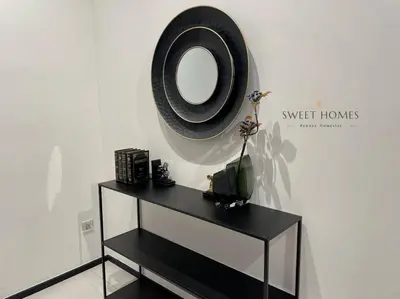 a black dresser with a mirror on a wall at Urban Modern3BR CityView 7pax Infinity Pool in George Town