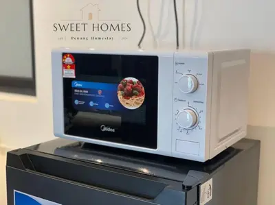 a microwave oven with a bowl of food inside at Urban Modern3BR CityView 7pax Infinity Pool in George Town