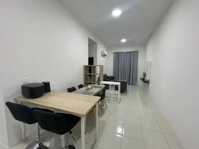 a living room with a table and chairs in a room at The Anderson Ipoh in Ipoh