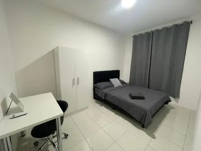 a bedroom with a bed and a desk and a desk at The Anderson Ipoh in Ipoh