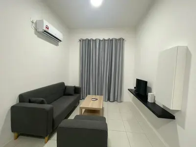 a living room with a couch and a table at The Anderson Ipoh in Ipoh