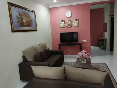a living room with a couch and a tv at Homestay Amin 4 Fully Aircond Bedroom & 2 Bathroom in Kulim