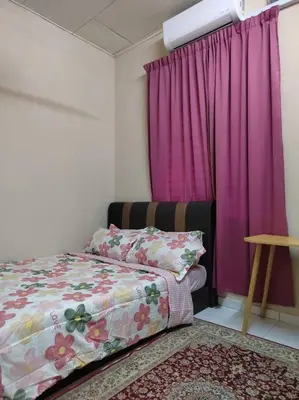 a bedroom with a bed and a pink curtain at Homestay Amin 4 Fully Aircond Bedroom & 2 Bathroom in Kulim
