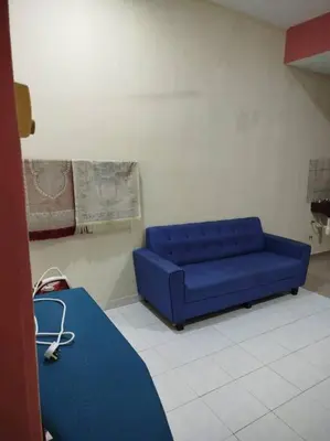 a blue couch sitting in a room with at Homestay Amin 4 Fully Aircond Bedroom & 2 Bathroom in Kulim
