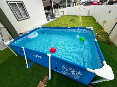 a pool table with two balls in a yard at Homestay Aishah in Seri Iskandar