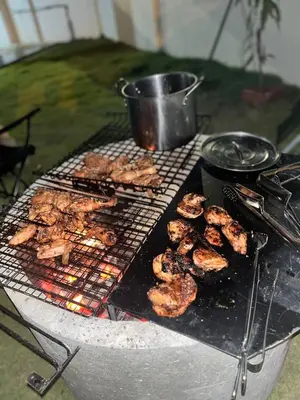 a grill with a bunch of food on it at Homestay Aishah in Seri Iskandar