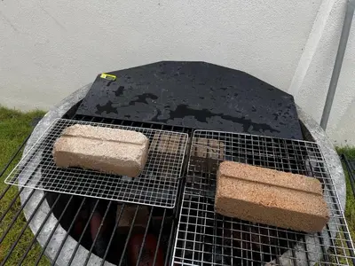 a grill with two pieces of food on it at Homestay Aishah in Seri Iskandar