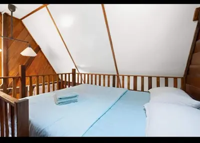 a bedroom with a large bed in a tent at Hillside cottage tulip room with loteng in Tanah Rata