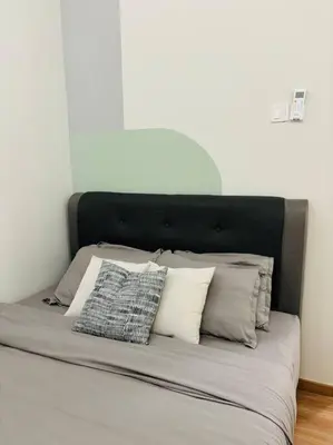a bed with white pillows and a black headboard at The Cove Hillside Ipoh by Iconique in Tambun