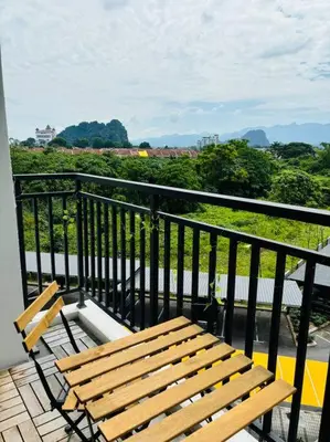 a wooden bench sitting on top of a balcony at The Cove Hillside Ipoh by Iconique in Tambun