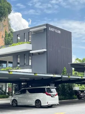 a white car parked in front of a building at The Cove Hillside Ipoh by Iconique in Tambun