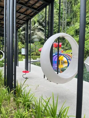 a large white circle sculpture in front of a playground at The Cove Hillside Ipoh by Iconique in Tambun