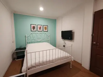 a small bedroom with a bed and a tv at Songtam Hotel in Ipoh