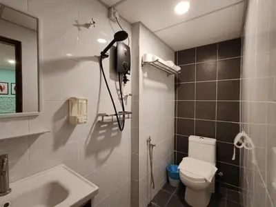 a bathroom with a toilet and a sink and a camera at Songtam Hotel in Ipoh