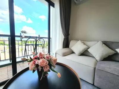a living room with a couch and a table with flowers on it at IPOH City Horizon08 - 8 mins to Concubine Lane and Old Town Ipoh, 3 mins Walking to Food Places & Convenient Store by Happy Homestay in Ipoh