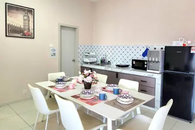 a kitchen with a table with white chairs and a refrigerator at IPOH City Horizon08 - 8 mins to Concubine Lane and Old Town Ipoh, 3 mins Walking to Food Places & Convenient Store by Happy Homestay in Ipoh