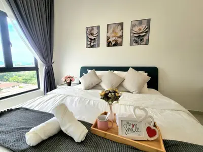 a bedroom with a bed with a tray with flowers on it at IPOH City Horizon08 - 8 mins to Concubine Lane and Old Town Ipoh, 3 mins Walking to Food Places & Convenient Store by Happy Homestay in Ipoh