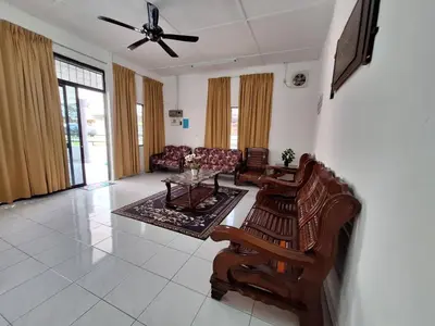 a living room with a couch and a table at Mukhriz 2 Homestay in Kulim