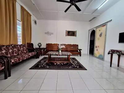 a living room with couches and a coffee table at Mukhriz 2 Homestay in Kulim