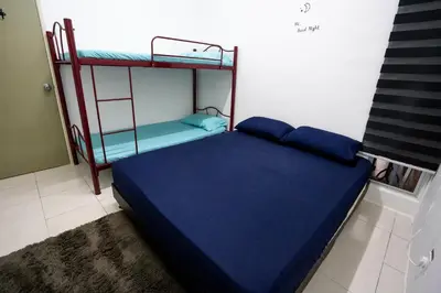 a bed in a room with a bunk bed at Cozy Homestay at Tanah Rata - Moonshot Highlanders in Tanah Rata