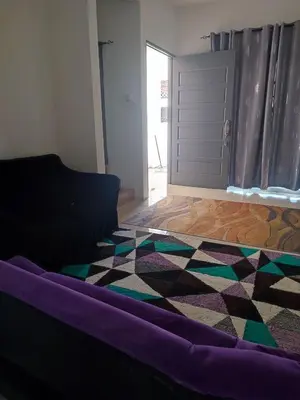 a living room with a couch and a geometric floor at Suriati&Fhaiz Homestay in Sungai Petani