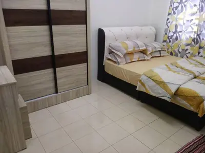a bedroom with a bed and a mirror at Suriati&Fhaiz Homestay in Sungai Petani