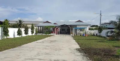 a house with a pathway in front of it at Seaside cottage room stays in Sungai Besar