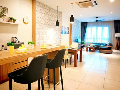 a kitchen and living room with a table and chairs at Ipoh Octagon Premium 7 Pax Condo One Free Parking by City Home Empire in Ipoh