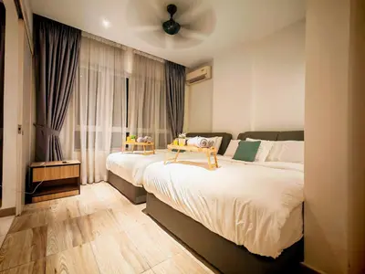 a bedroom with two beds and a ceiling fan at Ipoh Octagon Premium 7 Pax Condo One Free Parking by City Home Empire in Ipoh