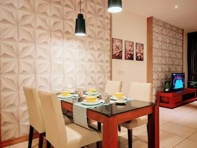 a dining room with a table and white chairs at Ipoh Octagon Premium 7 Pax Condo One Free Parking by City Home Empire in Ipoh