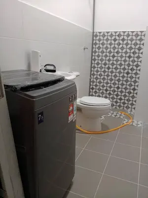 a bathroom with a toilet and a shower at Soho LESTARI in Seri Iskandar