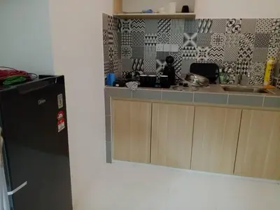 a kitchen with a sink and a refrigerator at Soho LESTARI in Seri Iskandar