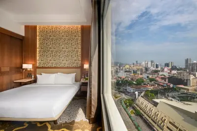 a bedroom with a white bed and a large window at St Giles Wembley Penang in George Town